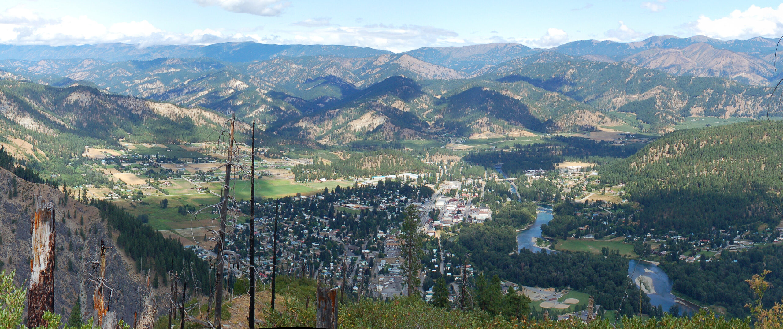 Elevated panoramic view of downtown Leavenworth, Washington, surrounded by Cascade Mountains and the Wenatchee River valley