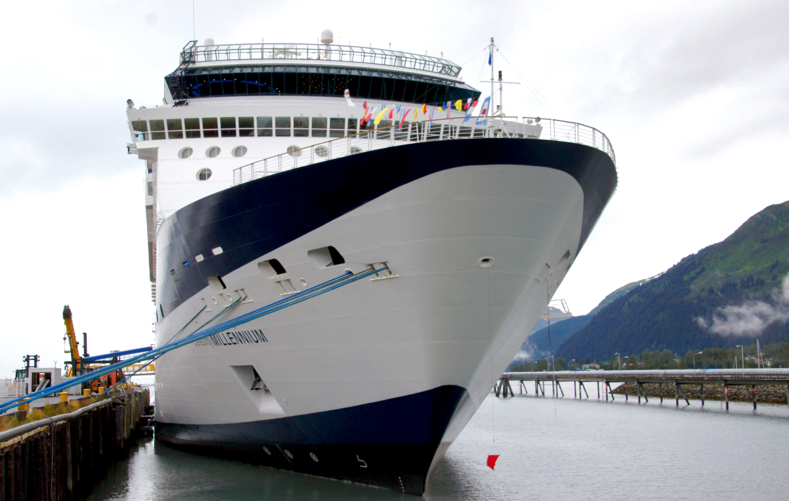 Celebrity Millennium cruise ship docked at Seward, Alaska with mountains and harbor water behind it