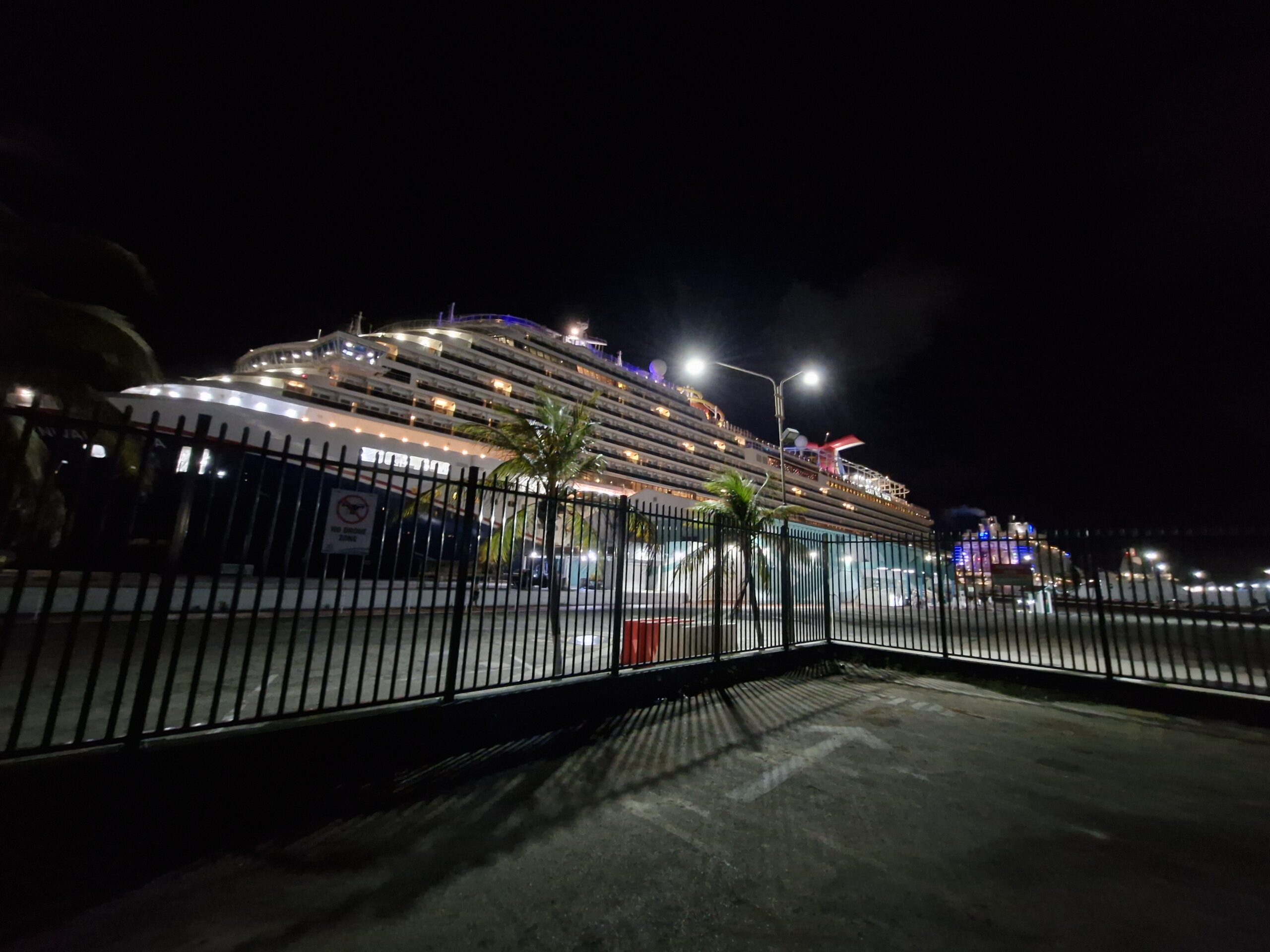 Cruise ship docked at night in the port of Oranjestad, Aruba