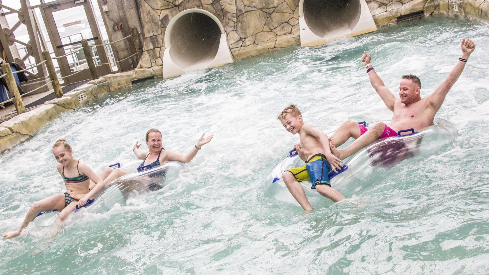 Family riding tubes in the Pump House Indoor Waterpark at Jay Peak Resort