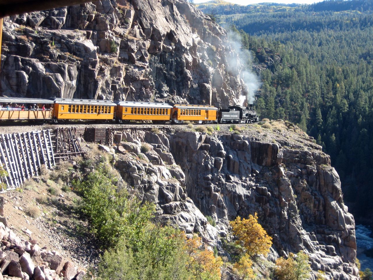 Durango & Silverton Narrow Gauge Railroad steam train traveling along a rocky mountainside in Colorado