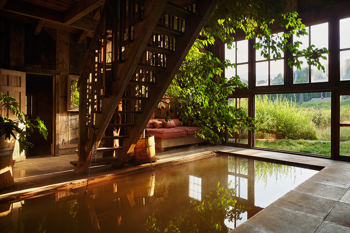 Sunlit historic bathhouse and geothermal soaking pool at Dunton Hot Springs in Colorado