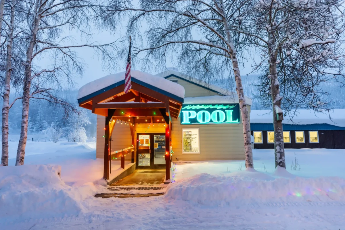 Snow-covered Pool House entrance at Chena Hot Springs Resort in Alaska