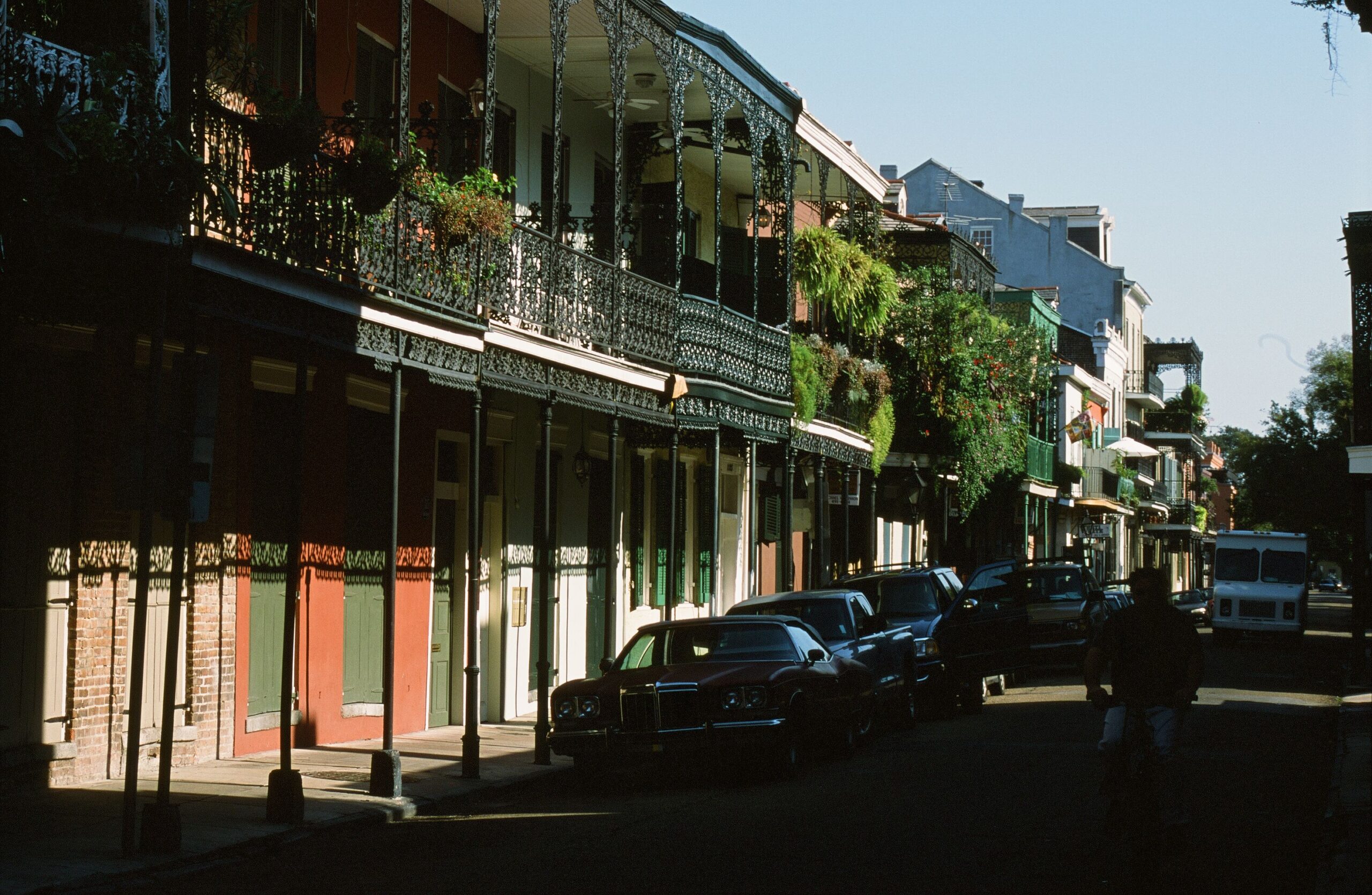 Historic French Quarter street lined with colorful buildings and wrought-iron balconies in New Orleans